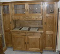 A 19th Century pine dresser with two central glazed doors enclosing shelves above twelve assorted