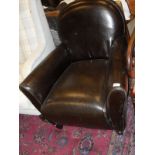 A brown leatherette single armchair on square section tapering supports