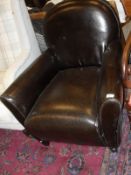 A brown leatherette single armchair on square section tapering supports