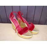 A pair of Yves St Laurent wedges with velvet straps and gold leather soles