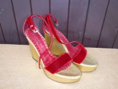 A pair of Yves St Laurent wedges with velvet straps and gold leather soles