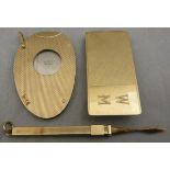 An Asprey engine turned 9 carat gold cased cigar cutter, a similar 9 carat gold toothpick,