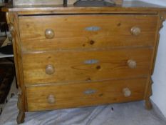 A pine three drawer commode, a 19th Century single door pot cupboard to plinth base,