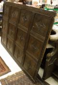 An 18th Century carved panel set with twelve floral carved panels
