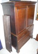An 18th Century oak cabinet on chest with two cupboard doors above two dummy drawers and two long