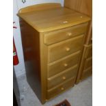 A modern beech bedroom suite comprising chest of five drawers,