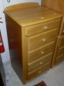 A modern beech bedroom suite comprising chest of five drawers,