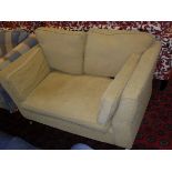 A pale gold two seat sofa on turned front legs to brass caps and castors CONDITION