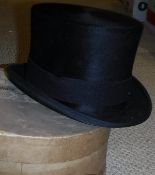 A ladies black top hat stamped "Moss Bros, Covent Garden" to the interior,