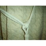 A pair of woven interlined curtains of cream checked design for a bay window,