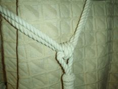 A pair of woven interlined curtains of cream checked design for a bay window,