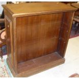 A pair of early 20th Century oak double sided bookcase with adjustable shelving on a plinth base