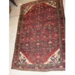 A Caucasian rug with all over pattern on a burgundy field with cream spandrels and a three margin