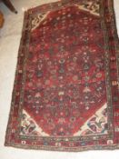 A Caucasian rug with all over pattern on a burgundy field with cream spandrels and a three margin