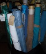 A box containing a large collection of assorted remnant rolls of fabric, mainly in blue,