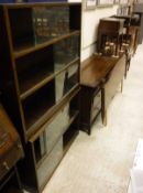 A Minty oak five section stacking bookcase with sliding doors,