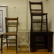 A three tier folding cake stand, two cane seated hall chairs, nest of three mahogany tables,