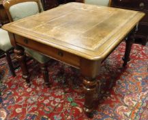 A Victorian mahogany writing table with a tooled brown leather inset top,