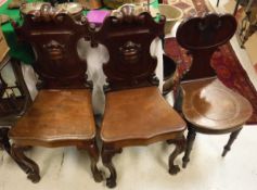 A 19th Century mahogany hall chair with carved and moulded back on turned front legs together with