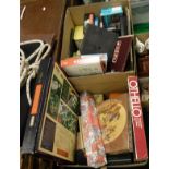 Two boxes of assorted games to include Scrabble, jigsaw puzzles,