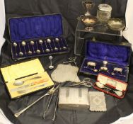 A box containing assorted silver and plated wares to include a cased three piece cruet,