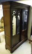 A 19th Century mahogany two door armoire with mirrored doors and applied mahogany mouldings,