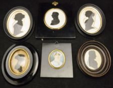 An early 19th Century miniature portrait of a woman with lace cap, housed in an ebonised frame,