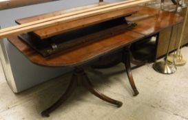 A reproduction mahogany Regency D-end dining table on twin pedestal supports,