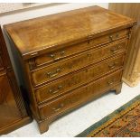 A walnut and feather banded bachelor's chest with fold-over top above four graduated drawers to