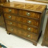 An oyster walnut and mahogany banded square chest of two short over three long graduated drawers,