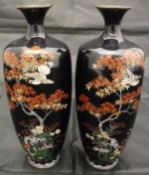 A pair of Japanese Meiji period cloisonné vases decorated with birds amongst maple and blossom