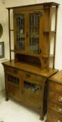 A circa 1900 oak display cabinet in the Art Nouveau taste with embossed copper fittings,