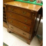 A small walnut and feather banded bachelor's chest of four drawers with fold-out top above the four