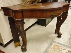 A Victorian mahogany serpentine fronted single drawer side table on carved cabriole legs with