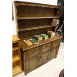 A 20th Century dresser with open shelves above a base of three drawers and three cupboard doors to