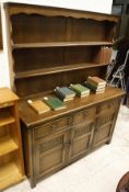 A 20th Century dresser with open shelves above a base of three drawers and three cupboard doors to
