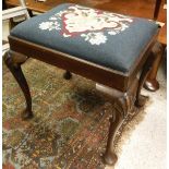 A mahogany stool on cabriole legs with shell carving to the knees to pad feet