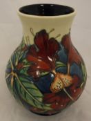 A Moorcroft baluster shaped vase with all over floral decoration bearing stamps and initials "L K /