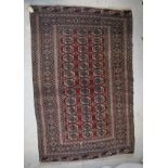 A Bokhara rug on a red ground with thirty-nine elephant foot ghuls,