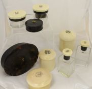 A collection of early 20th Century silver mounted ivory and tortoiseshell dressing table bottles,