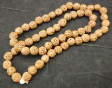 A carved coquilla nut necklace CONDITION REPORTS All have general wear and tear,