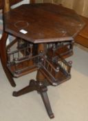 A 20th Century mahogany centre table with octagonal top turned pedestal to galleried second tier