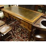 A 20th Century mahogany desk, the green tooled leather inset top,