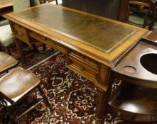 A 20th Century mahogany desk, the green tooled leather inset top,