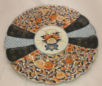 A 19th Century Imari charger with scalloped edge and floral panel decoration,