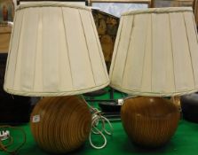 Two turned treen bodied table lamp bases with cream pleated shades