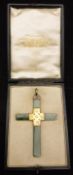 A jade and gilt metal mounted pendant in the form of a cross,