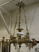 An early 20th Century Continental gilt brass chandelier in the Rococo taste,