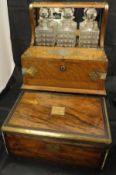 A Victorian oak and brass bound tantalus with three hobnail decanters and twin-lidded compartment