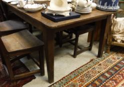 A 19th Century fruitwood plank top rectangular kitchen table with cleated end supports,